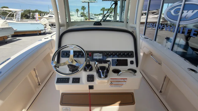 Slide: The Image of The image shows the helm of a Grady-White Canyon 266 boat with modern controls. - 22
