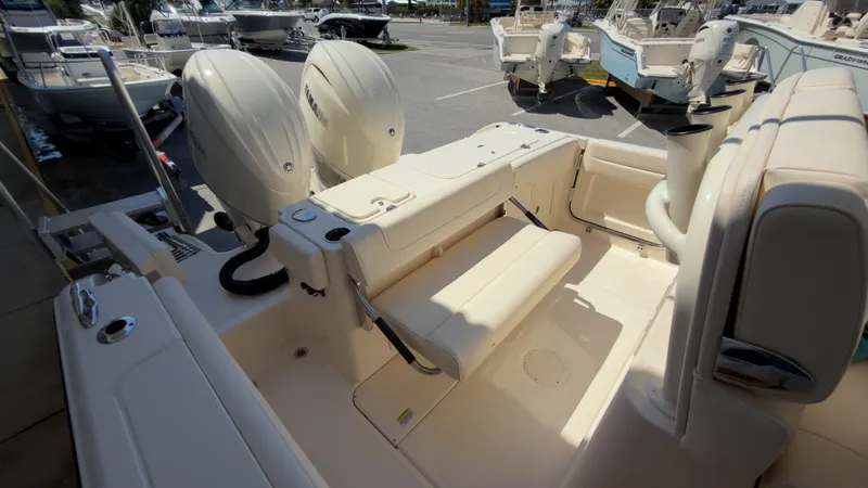Slide: The Image of The image shows the cockpit of a Grady-White Canyon 266 boat with dual engines and seating. - 37