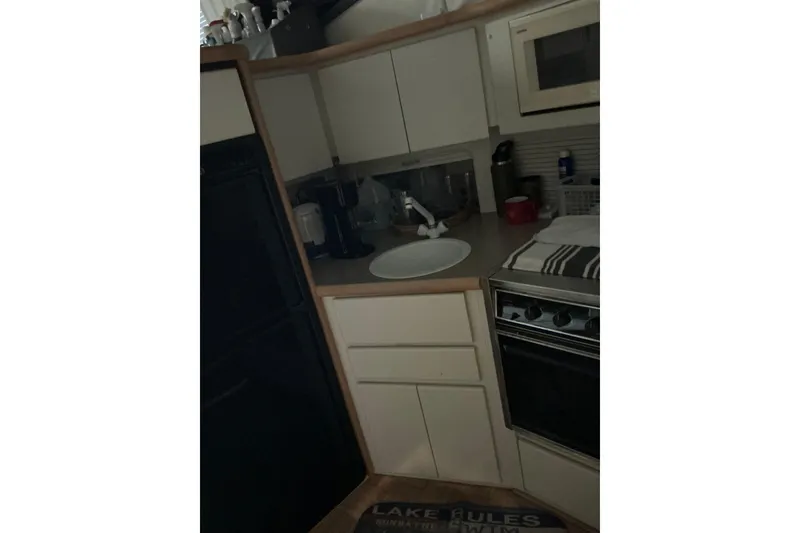 Slide: The Image of Compact kitchen area in a 1995 Carver 355 Aft Cabin Motor Yacht. - 19