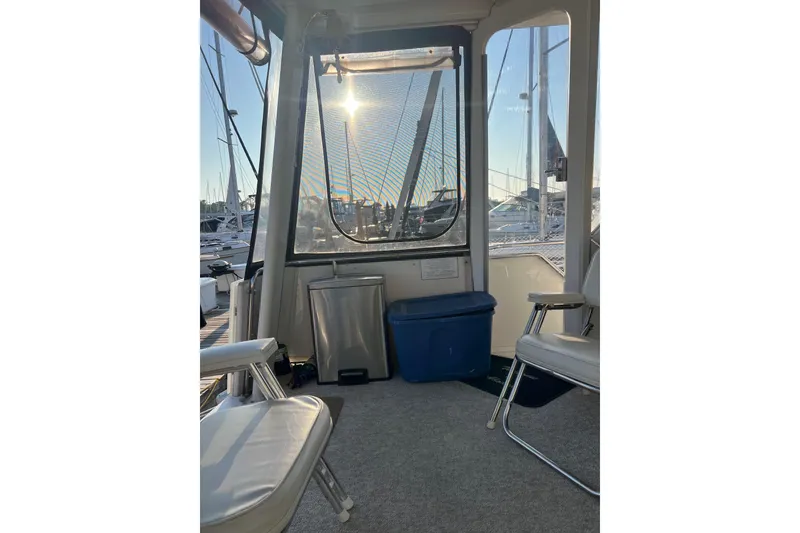 Slide: The Image of Interior view of 1995 Carver 355 Aft Cabin Motor Yacht with marina backdrop. - 25