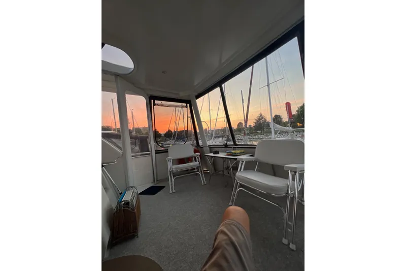 Slide: The Image of Interior of 1995 Carver 355 Aft Cabin Motor Yacht at sunset, with marina view. - 26