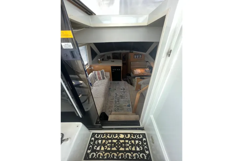 Slide: The Image of Interior view of 1995 Carver 355 Aft Cabin Motor Yacht, featuring cozy seating and nautical decor. - 27