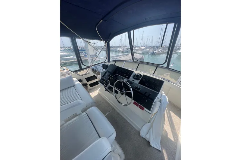 Slide: The Image of Interior helm of 1995 Carver 355 Aft Cabin Motor Yacht with marina view. - 29