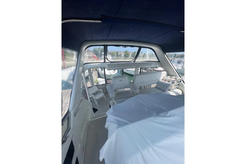 Slide: The Image of 1995 Carver 355 Aft Cabin Motor Yacht interior with seating and helm view. - 30