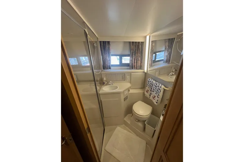 Slide: The Image of Bathroom interior of 1995 Carver 355 Aft Cabin Motor Yacht, featuring sink and toilet. - 31