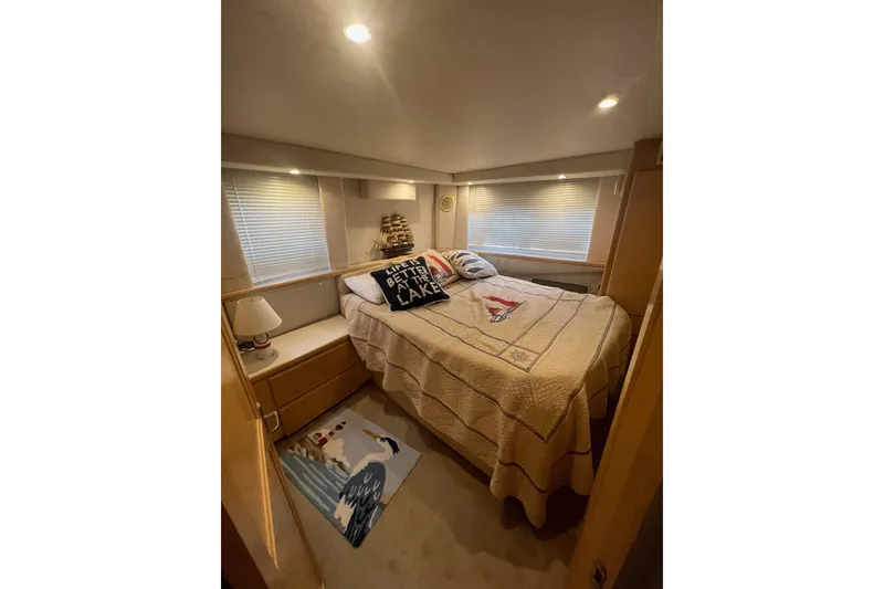 Slide: The Image of Cozy bedroom in 1995 Carver 355 Aft Cabin Motor Yacht with nautical decor. - 32