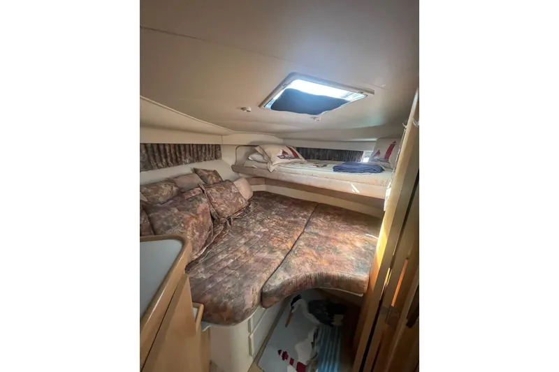 Slide: The Image of Cozy cabin interior of 1995 Carver 355 Aft Cabin Motor Yacht with plush bedding. - 33