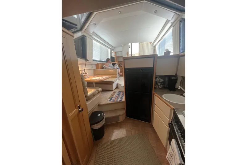 Slide: The Image of Interior of 1995 Carver 355 Aft Cabin Motor Yacht, featuring kitchen and seating area. - 34