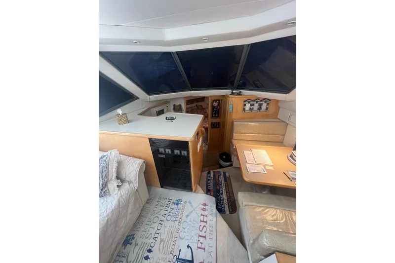 Slide: The Image of Interior of 1995 Carver 355 Aft Cabin Motor Yacht with cozy seating and nautical decor. - 36