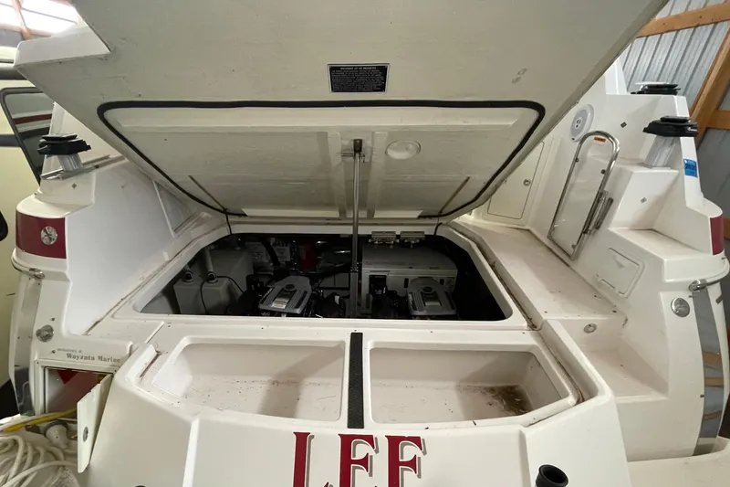 Slide: The Image of 2013 Regal 35 Sport Coupe engine compartment with open hatch in a marina setting. - 16