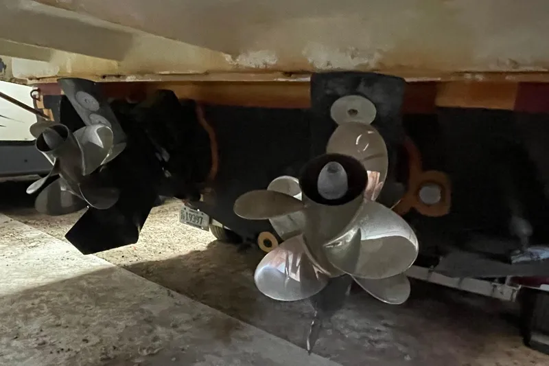 Slide: The Image of Propellers of a 2013 Regal 35 Sport Coupe boat in a garage setting. - 18