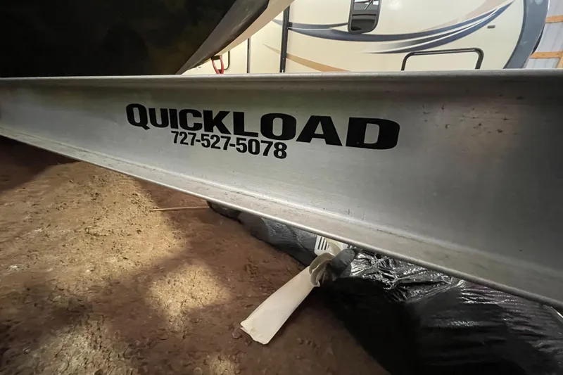 Slide: The Image of Quickload trailer for 2013 Regal 35 Sport Coupe, parked on dirt surface. - 20