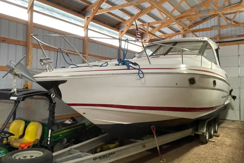 Slide: The Image of 2013 Regal 35 Sport Coupe boat stored in a wooden garage. - 21
