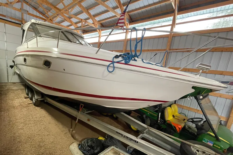 Slide: The Image of 2013 Regal 35 Sport Coupe boat in a wooden garage, on a trailer. - 23