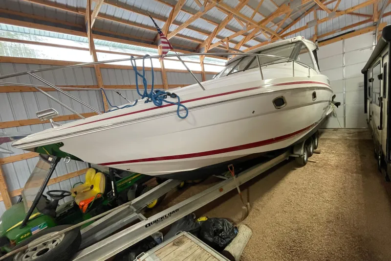 Slide: The Image of 2013 Regal 35 Sport Coupe boat stored indoors on a trailer. - 24