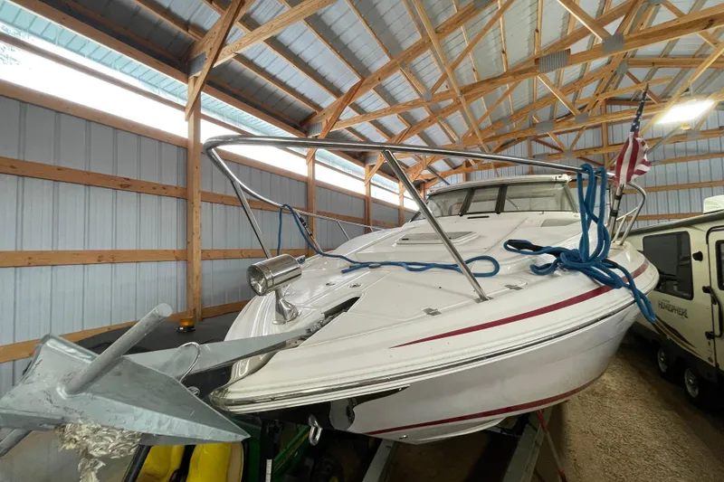 Slide: The Image of 2013 Regal 35 Sport Coupe boat stored in a wooden shed with an American flag. - 25