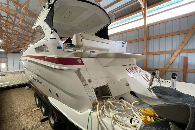 Slide: The Image of 2013 Regal 35 Sport Coupe boat in storage, featuring sleek design and red accents. - 26