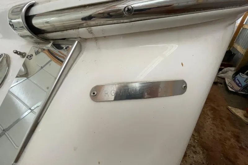 Slide: The Image of Close-up of a 2013 Regal 35 Sport Coupe boat's metal nameplate and railing. - 27