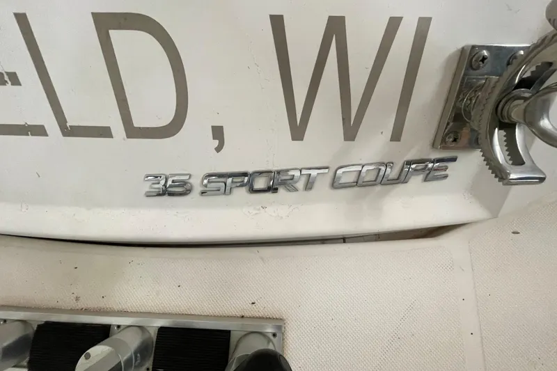 Slide: The Image of 2013 Regal 35 Sport Coupe boat emblem on white surface. - 29