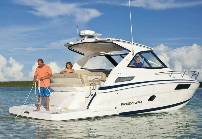 Slide: The Image of Manufacturer Provided Image: 2013 Regal 35 Sport Coupe yacht on calm water with people onboard. - 3