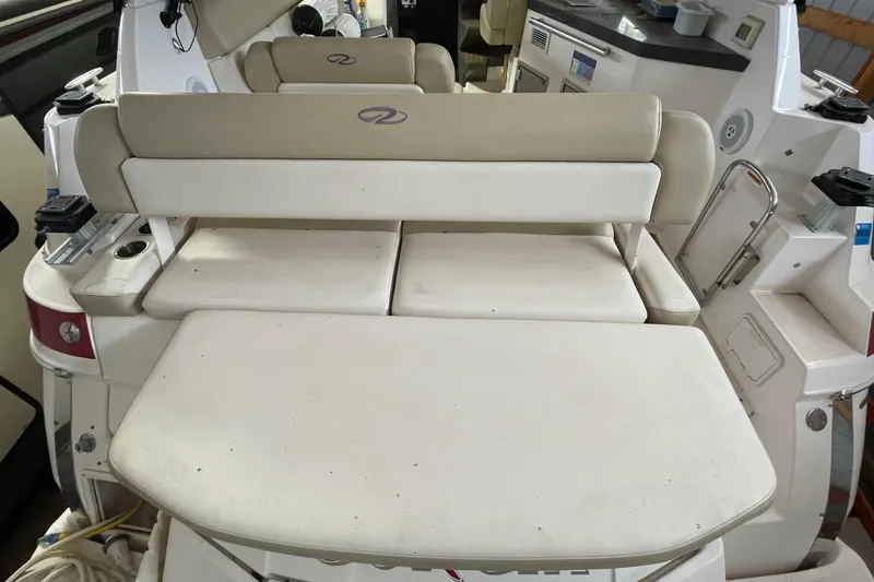 Slide: The Image of Interior seating of a 2013 Regal 35 Sport Coupe boat, featuring beige upholstery. - 30
