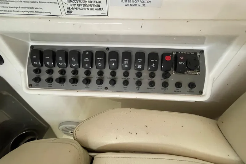 Slide: The Image of Control panel of a 2013 Regal 35 Sport Coupe boat with labeled switches. - 32