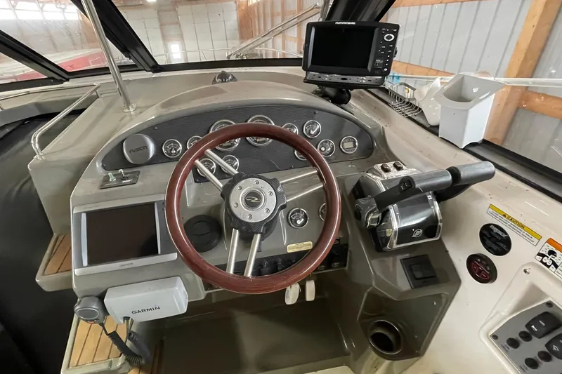 Slide: The Image of Cockpit of 2013 Regal 35 Sport Coupe with steering wheel and navigation equipment. - 33