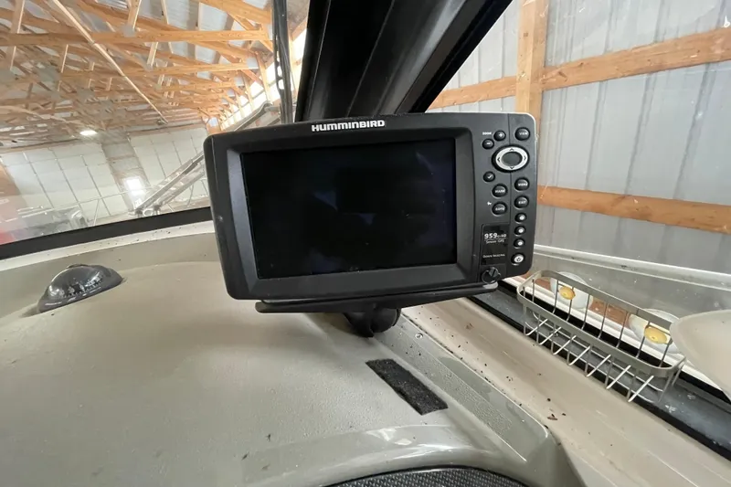 Slide: The Image of Humminbird fish finder on 2013 Regal 35 Sport Coupe dashboard in a garage setting. - 34