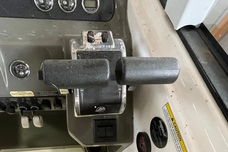 Slide: The Image of Control panel of a 2013 Regal 35 Sport Coupe boat with throttle levers. - 36