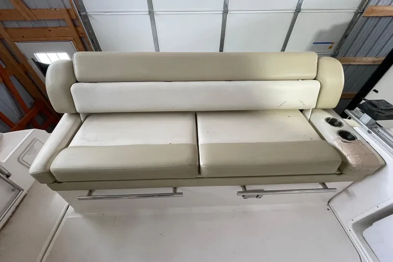 Slide: The Image of Beige seating on 2013 Regal 35 Sport Coupe boat with cup holders in garage. - 39