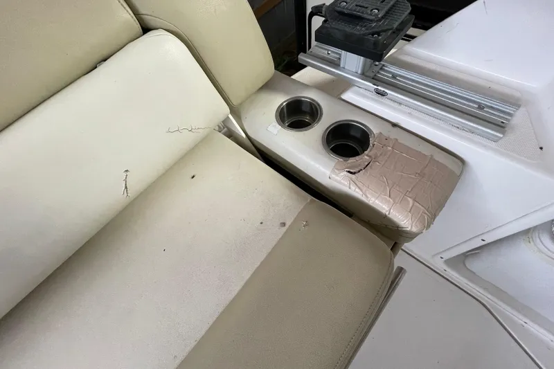 Slide: The Image of 2013 Regal 35 Sport Coupe interior with worn beige seats and cup holders. - 40