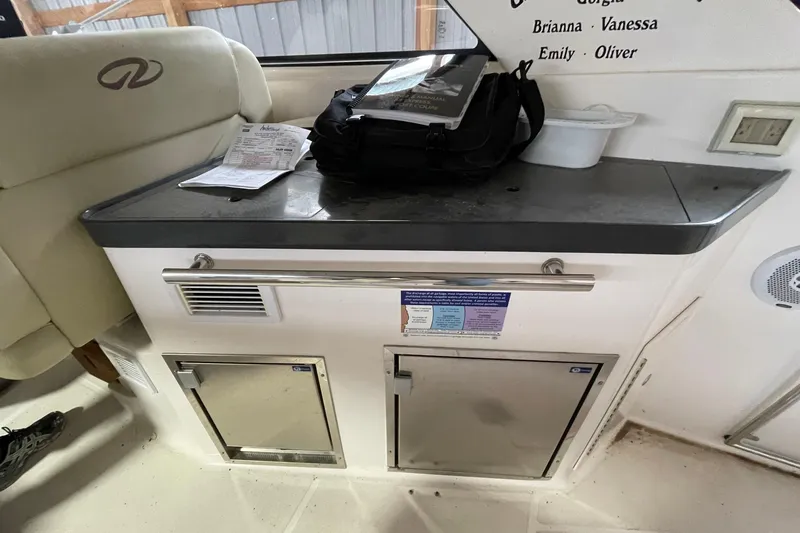 Slide: The Image of Interior of a 2013 Regal 35 Sport Coupe with storage compartments and countertop. - 42