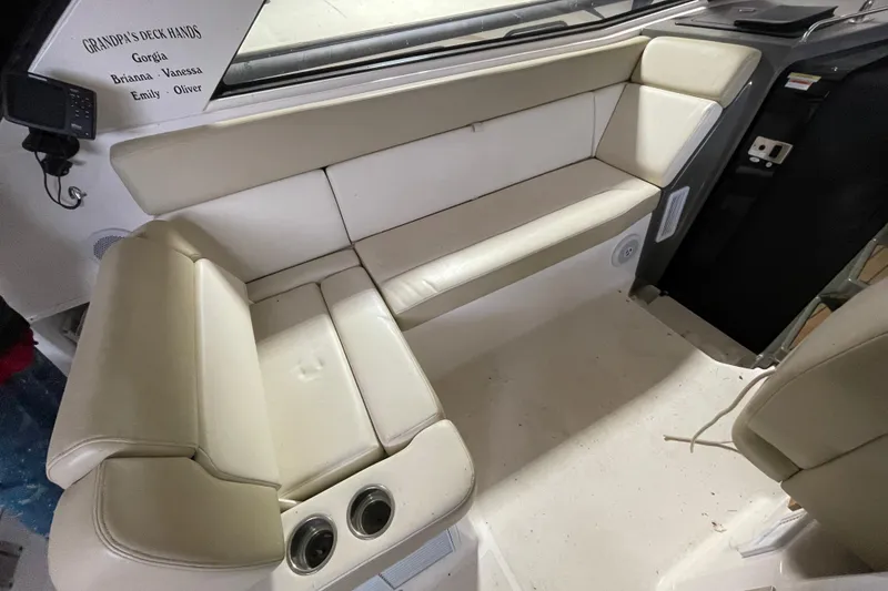 Slide: The Image of Interior seating of a 2013 Regal 35 Sport Coupe boat with beige upholstery. - 44