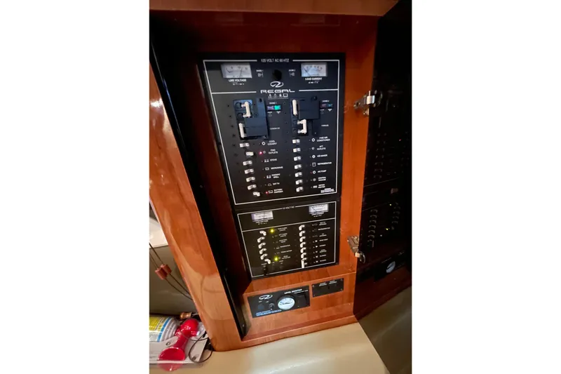 Slide: The Image of Electrical panel of 2013 Regal 35 Sport Coupe boat, featuring switches and controls. - 48