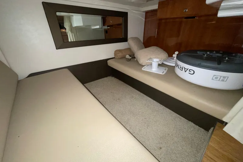 Slide: The Image of Interior cabin of 2013 Regal 35 Sport Coupe with beige seating and carpet. - 50