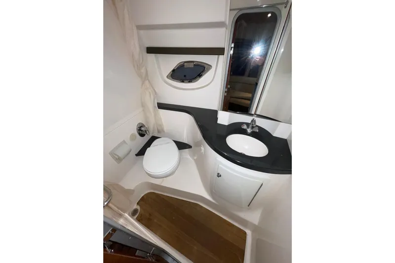 Slide: The Image of Bathroom interior of 2013 Regal 35 Sport Coupe yacht, featuring sink and toilet. - 54