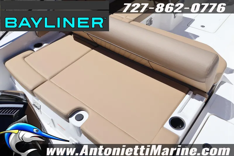 Slide: The Image of 2026 Bayliner D22 boat with tan seating, cup holders, and branding details. - 13