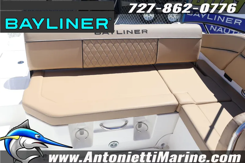 Slide: The Image of 2026 Bayliner D22 boat seating with tan upholstery, featuring diamond stitching and branding. - 16