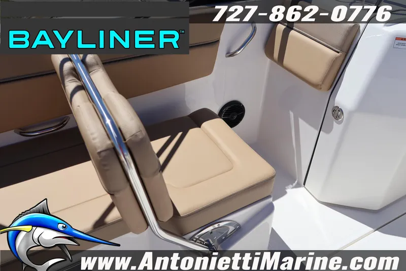 Slide: The Image of 2026 Bayliner D22 boat interior with beige seating, chrome accents, and branding details. - 18