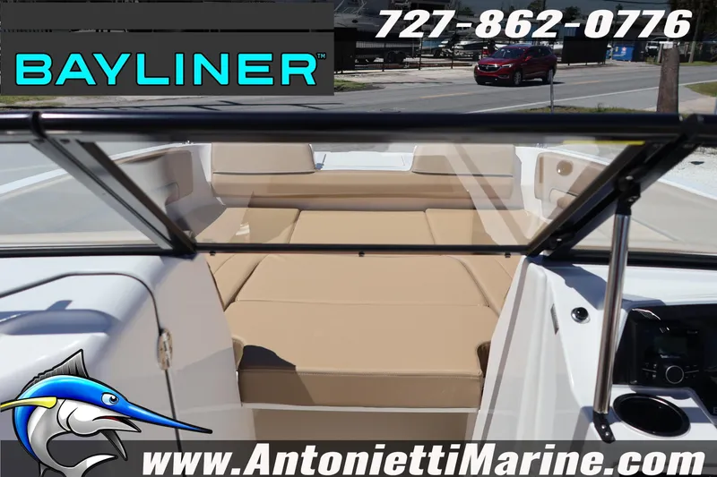 Slide: The Image of Bayliner D22 2026 boat interior with tan seating, windshield, and contact details. - 24