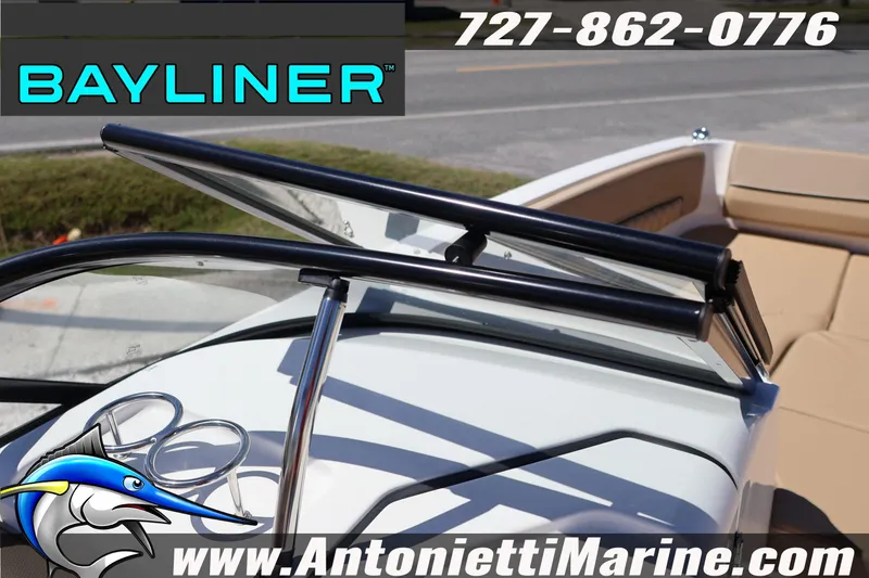 Slide: The Image of 2026 Bayliner D22 boat with open windshield, cup holders, and tan seating. - 25