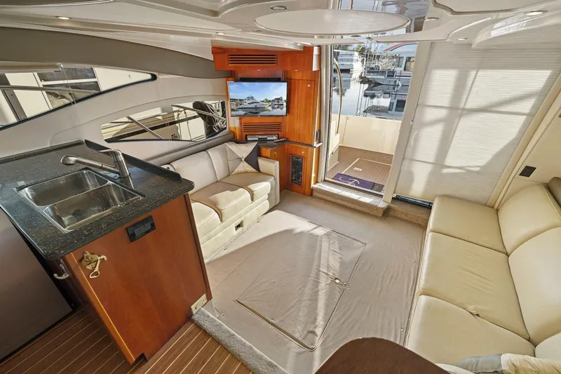 Slide: The Image of Luxurious interior of 2008 Cruisers Yachts 447 Sport Sedan with plush seating and kitchenette. - 12