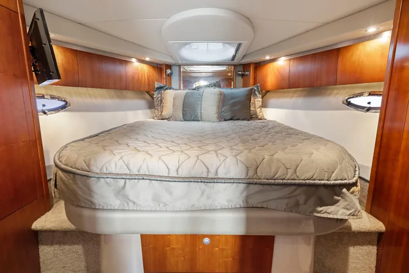 Slide: The Image of Luxurious cabin interior of 2008 Cruisers Yachts 447 Sport Sedan with cozy bed and wood paneling. - 18