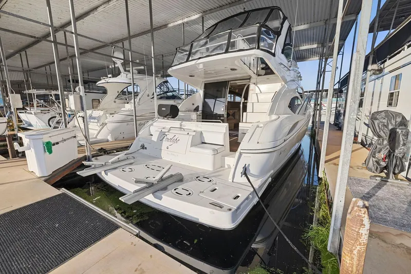 Slide: The Image of 2008 Cruisers Yachts 447 Sport Sedan docked in a marina, rear view. - 2