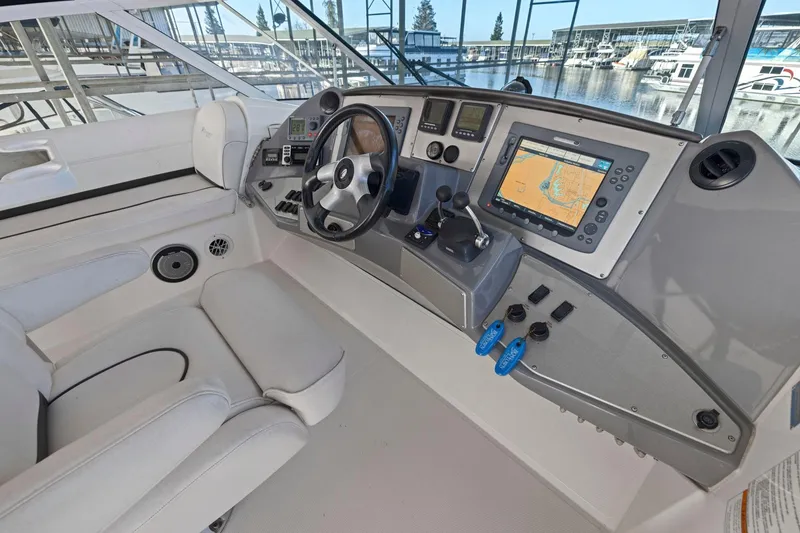 Slide: The Image of 2008 Cruisers Yachts 447 Sport Sedan helm with navigation system and controls. - 28