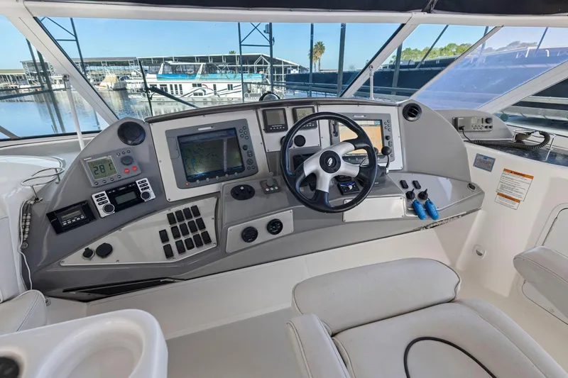 Slide: The Image of 2008 Cruisers Yachts 447 Sport Sedan helm with navigation equipment and steering wheel. - 29