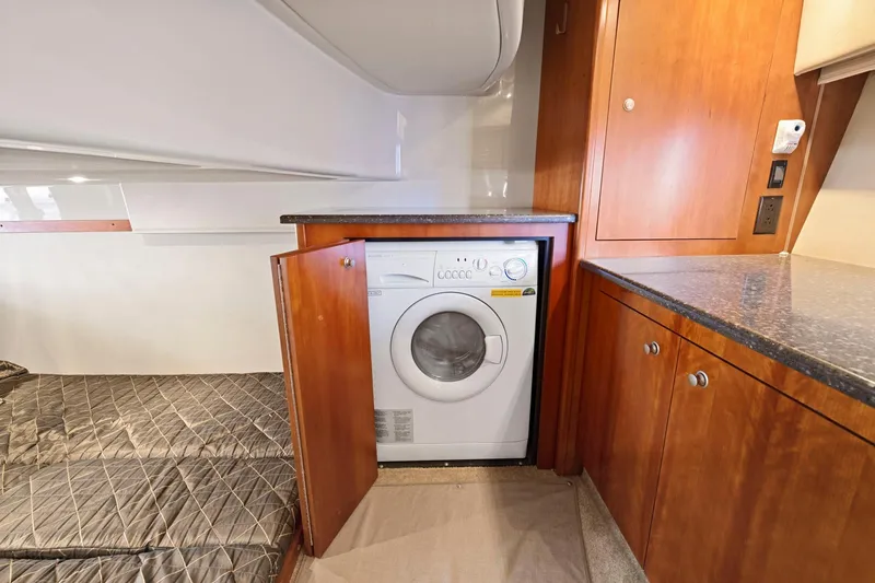 Slide: The Image of 2008 Cruisers Yachts 447 Sport Sedan interior with washer in wooden cabinet. - 34