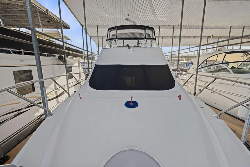 Slide: The Image of 2008 Cruisers Yachts 447 Sport Sedan docked under a covered marina. - 40