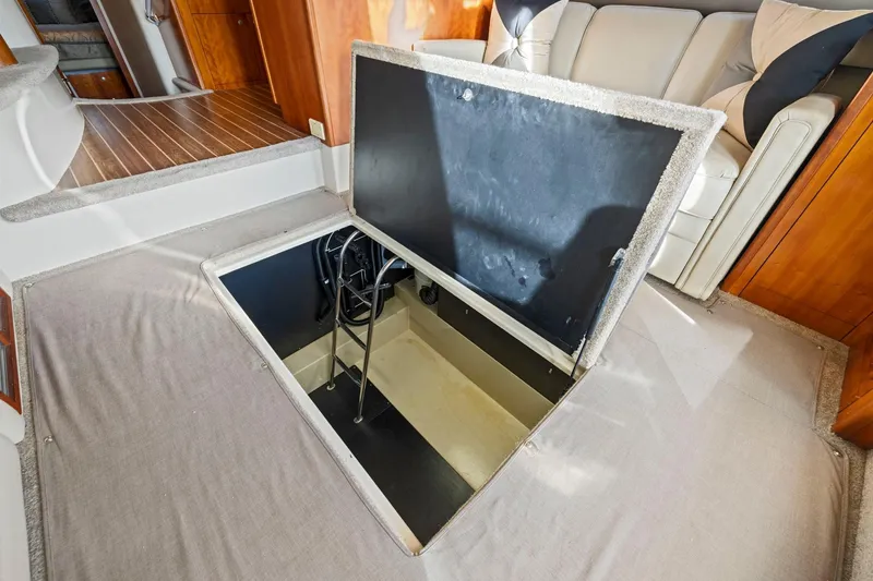 Slide: The Image of Open hatch in 2008 Cruisers Yachts 447 Sport Sedan interior, revealing storage space. - 42