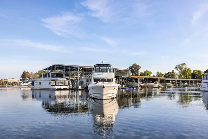 Slide: The Image of 2008 Cruisers Yachts 447 Sport Sedan docked at a marina under clear blue skies. - 55